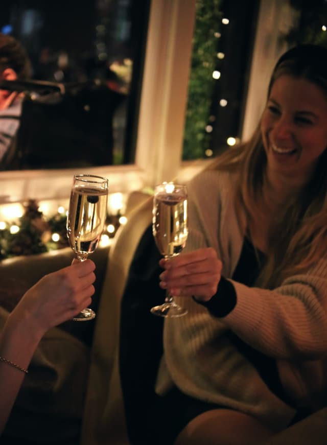 People doing a cheers with champagne